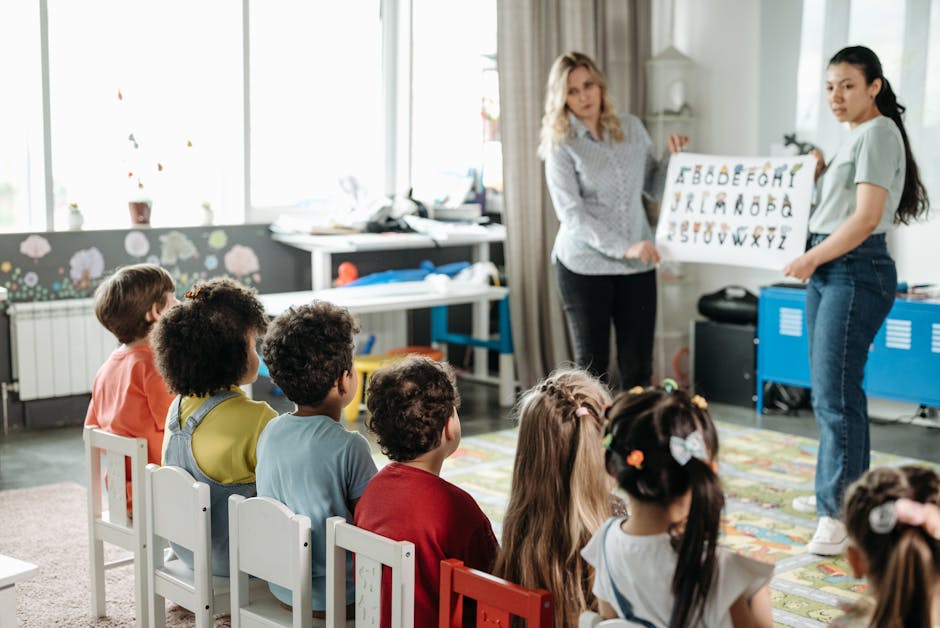 Teachers engage children in learning alphabet during a kindergarten class